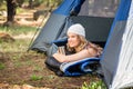 Pretty blonde camper smiling and lying in tent Royalty Free Stock Photo