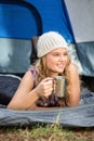 Pretty blonde camper smiling and lying in tent Royalty Free Stock Photo