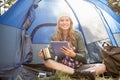 Pretty blonde camper using tablet and holding cup Royalty Free Stock Photo