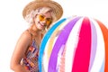 Pretty blonde caucasian female stands in swimsuit with big rubber beach colourful ball and smiles isolated on white