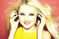 Pretty blonde dg girl in headset on pink Royalty Free Stock Photo