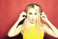 Pretty blonde dg girl in headset on pink Royalty Free Stock Photo