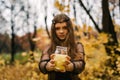 Pretty blonde girl in the autumn yellow fall park. Creative Halloween Day