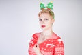 Pretty blonde girl with short hair wearing christmas funny bright dress on white studio background alone Royalty Free Stock Photo