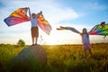 Pretty blonde girl and small boy with bright butterfly wings having fun in meadow or field on natural landscape with Royalty Free Stock Photo