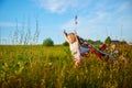 Pretty blonde girl and small boy with bright butterfly wings having fun in meadow or field on natural landscape with Royalty Free Stock Photo