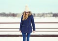 Pretty blonde girl wearing a jacket, hat and sunglasses Royalty Free Stock Photo