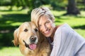 Pretty blonde with her dog in the park Royalty Free Stock Photo