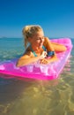 Pretty blonde on inflatable raft Royalty Free Stock Photo