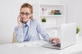 Pretty blonde office girl talking phone at her workplace. Royalty Free Stock Photo