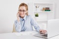 Pretty blonde office girl talking phone at her workplace. Royalty Free Stock Photo