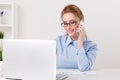 Pretty blonde office girl talking phone at her workplace. Royalty Free Stock Photo