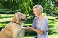 Pretty blonde playing with her dog in the park Royalty Free Stock Photo