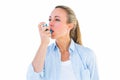 Pretty blonde using an asthma inhaler