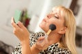 Pretty Blonde Woman Applying Her Makeup