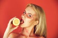 Pretty blonde woman with creative fashionable makeup lick lemon, vitamin Royalty Free Stock Photo