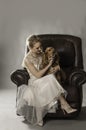 Pretty blonde woman with dog on her lap Royalty Free Stock Photo