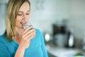 Pretty blonde woman drinking a glass of water Royalty Free Stock Photo