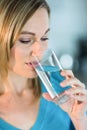 Pretty blonde woman drinking a glass of water Royalty Free Stock Photo