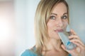 Pretty blonde woman drinking a glass of water Royalty Free Stock Photo