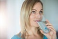 Pretty blonde woman drinking a glass of water Royalty Free Stock Photo