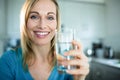 Pretty blonde woman drinking a glass of water Royalty Free Stock Photo