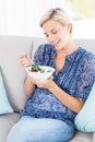 Pretty blonde woman eating bowl of salad Royalty Free Stock Photo