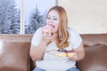 Pretty blonde woman eating donuts Royalty Free Stock Photo