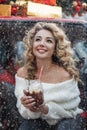 pretty blonde woman having ful outdoors in winter snowy weather. with mug of cocoa. smiling Royalty Free Stock Photo