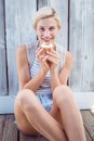 Pretty blonde woman holding cupcake Royalty Free Stock Photo