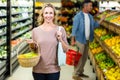 Pretty blonde woman holding vegetables basket Royalty Free Stock Photo