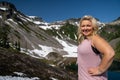 Pretty blonde woman poses at Heather Meadows in the Mount Baker area of Washington State on a sunny day Royalty Free Stock Photo