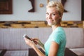 Pretty blonde woman using her smartphone Royalty Free Stock Photo