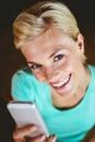 Pretty blonde woman using her smartphone Royalty Free Stock Photo