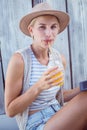 Pretty blonde woman using her tablet and drinking orange juice Royalty Free Stock Photo