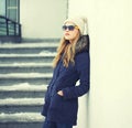 Pretty blonde woman wearing jacket, hat and sunglasses Royalty Free Stock Photo