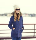 Pretty blonde woman wearing a jacket, hat and sunglasses Royalty Free Stock Photo