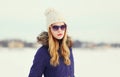 Pretty blonde woman wearing a jacket, hat and sunglasses Royalty Free Stock Photo