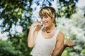 Pretty blonde young woman doing call me sign with Royalty Free Stock Photo