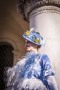 Masked woman in the Venice carnival with a blue costume