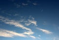 Pretty blue skies with trail of wispy clouds moving across the surface