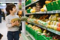 Pretty boy with pineapple in supermarket Royalty Free Stock Photo