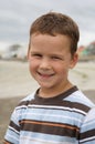 Pretty boy smiling on beach Royalty Free Stock Photo