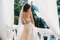 Pretty bride with beautiful bouquet of flowers in hands. Attractive young woman in white dress with wedding make-up on Royalty Free Stock Photo