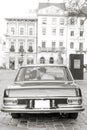 Pretty bride and handsome groom kissing and hugging in the retro car. Wedding day, retro style, old city center Royalty Free Stock Photo