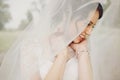 Pretty bride smiles shying under a veil Royalty Free Stock Photo