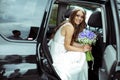 Pretty bride smiles sitting in the car Royalty Free Stock Photo