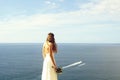 Pretty bride in white dress with wedding bouquet Royalty Free Stock Photo