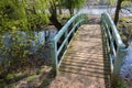 Pretty bridge over stream. Picturesque  country landscape. Painted wooden footbridge Royalty Free Stock Photo
