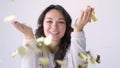 Pretty brunette blowing on candy, christmas mood. Attractive happy girl blowing gold glitter confetti with hands